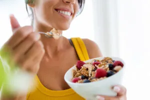 Smiling Lady Eating a Healthy Breakfast